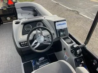 Slide: The Image of 2024 Barletta C22UC boat dashboard with steering wheel and navigation system. - 5