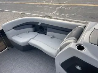Slide: The Image of 2024 Barletta C22UC boat interior with gray seating and cup holder. - 6