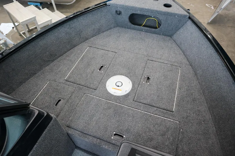 Slide: The Image of 2025 Crestliner 1650 KODIAK WT boat interior with carpeted deck and storage compartments. - 10