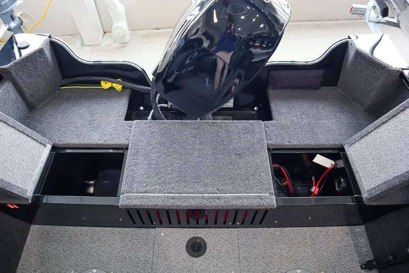 Slide: The Image of 2025 Crestliner 1650 KODIAK WT boat interior with storage compartments and motor. - 5