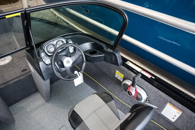 Slide: The Image of 2025 Crestliner 1650 KODIAK WT boat interior with steering wheel and control panel. - 8