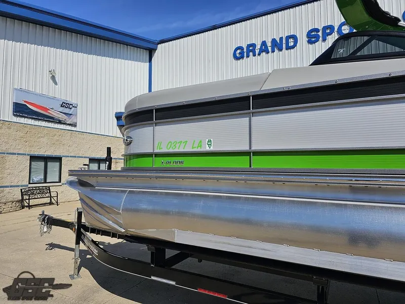 Slide: The Image of 2021 Manitou 25 X-Plode pontoon boat at dealership, green and silver exterior. - 14