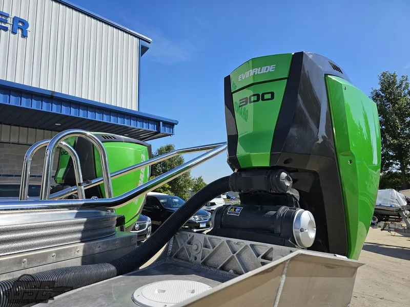 Slide: The Image of 2021 Manitou 25 X-Plode with Evinrude 300 engine, parked outdoors. - 19