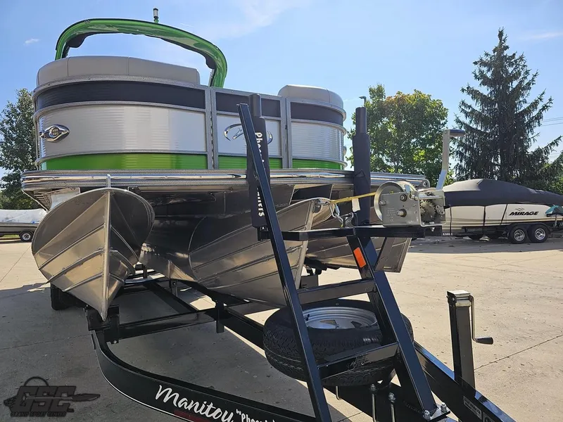 Slide: The Image of 2021 Manitou 25 X-Plode pontoon boat on trailer, parked outdoors. - 21