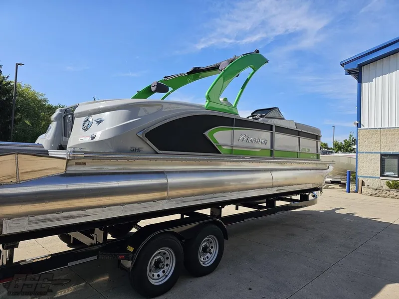 Slide: The Image of 2021 Manitou 25 X-Plode pontoon boat on trailer, featuring sleek design and vibrant green accents. - 35