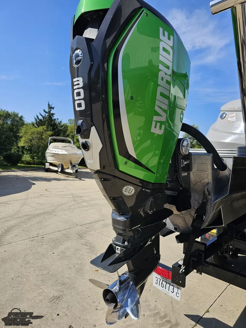 Slide: The Image of 2021 Manitou 25 X-Plode with green Evinrude 300 outboard motor. - 40