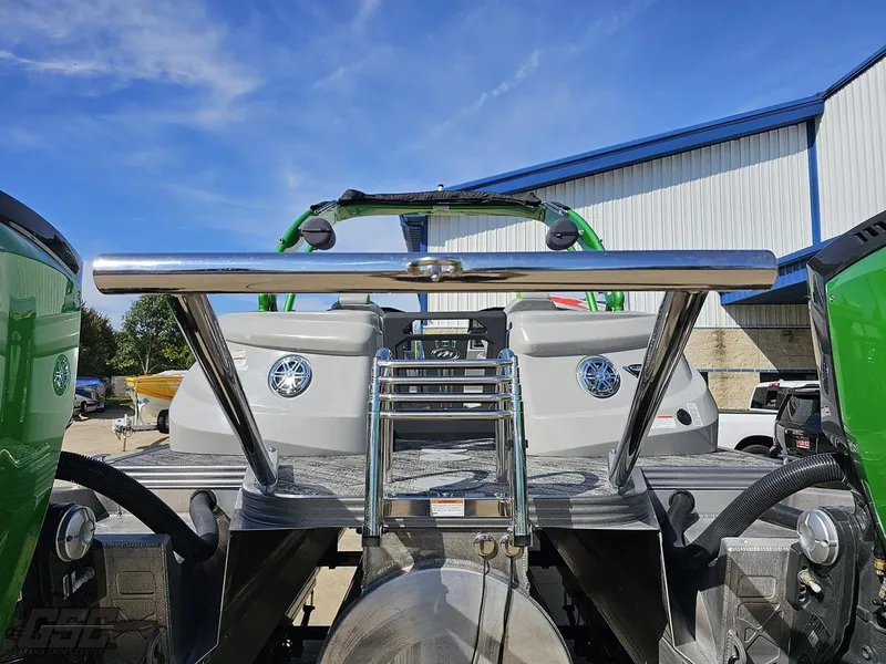 Slide: The Image of 2021 Manitou 25 X-Plode boat, rear view with stainless steel ladder and green accents. - 46