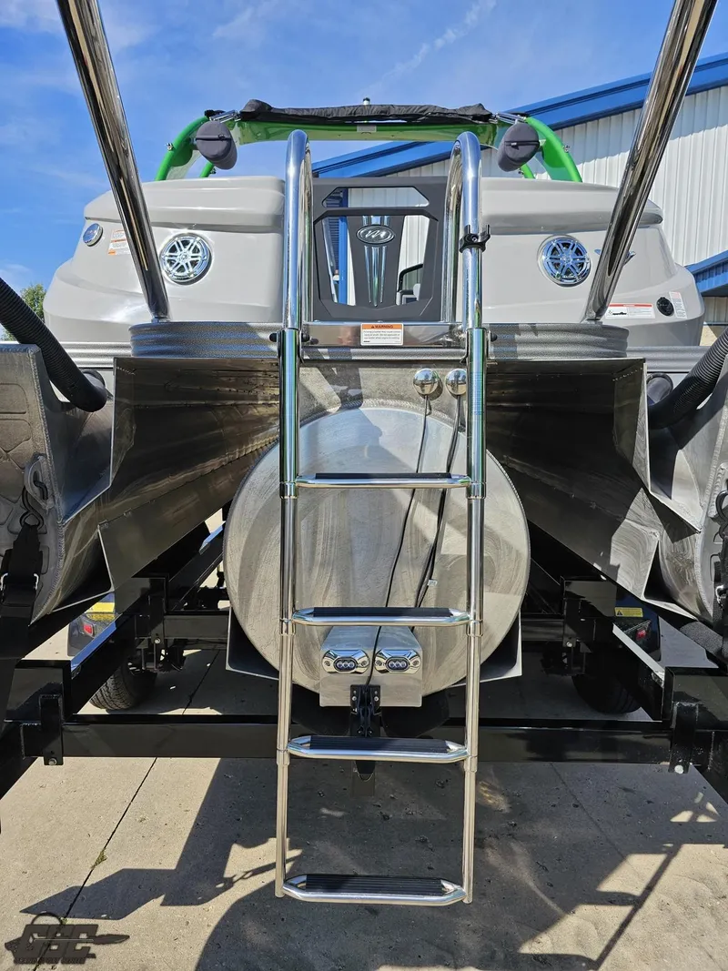 Slide: The Image of 2021 Manitou 25 X-Plode boat rear view with ladder and metallic finish. - 48