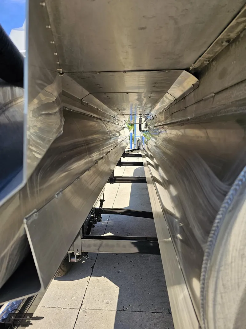 Slide: The Image of 2021 Manitou 25 X-Plode pontoon boat undercarriage, showcasing sleek aluminum construction. - 49