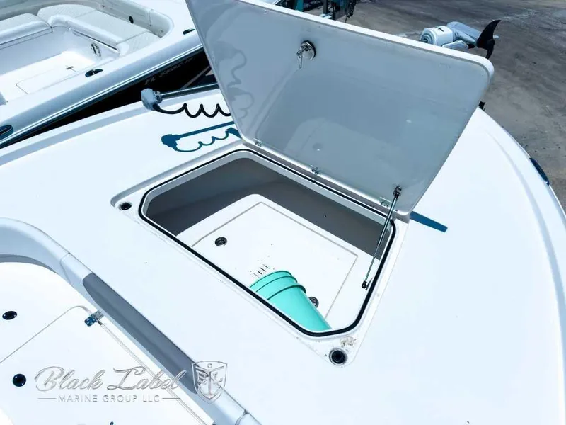 Slide: The Image of 2024 Caymas 281 HB boat with twin outboard engines, displayed outdoors under a cloudy sky. - 11