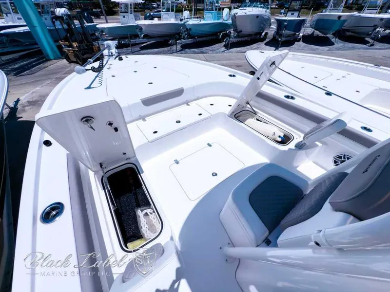 Slide: The Image of 2024 Caymas 281 HB boat on trailer, parked outdoors under a sunny sky. - 12