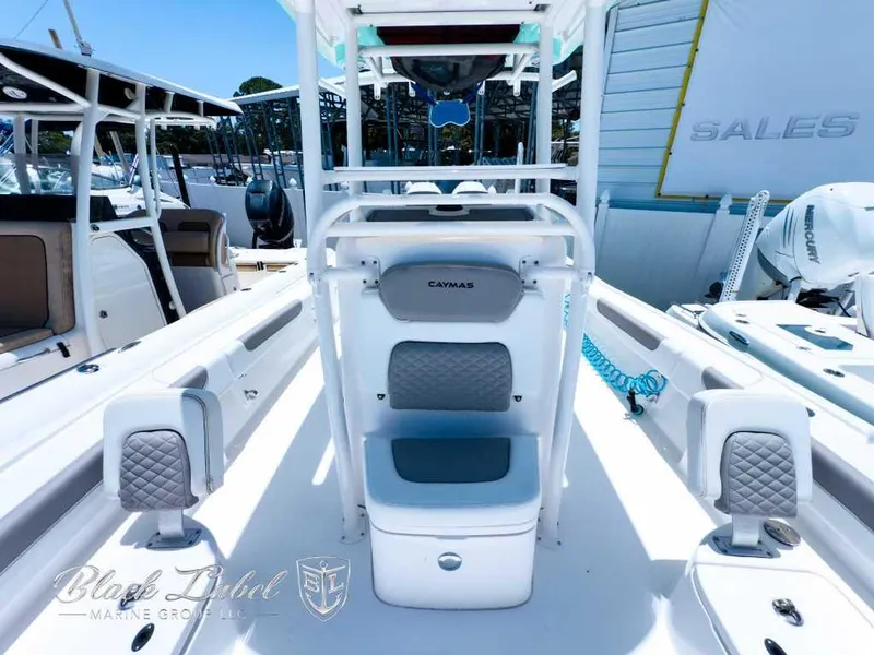 Slide: The Image of 2024 Caymas 281 HB boat in warehouse, mint green hull, white interior. - 14