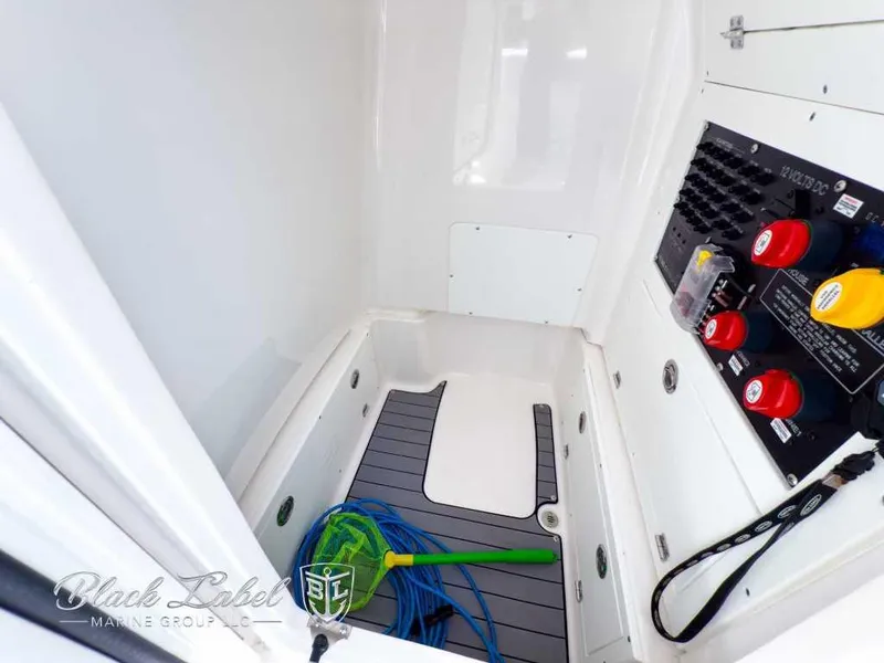 Slide: The Image of 2024 Caymas 281 HB boat interior with control panel and storage area. - 19