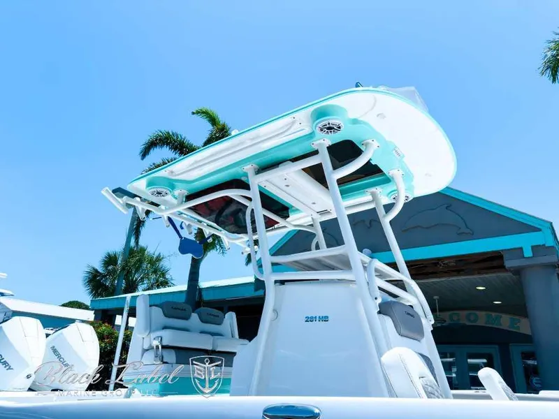 Slide: The Image of 2024 Caymas 281 HB boat in a warehouse, featuring a light blue hull. - 2