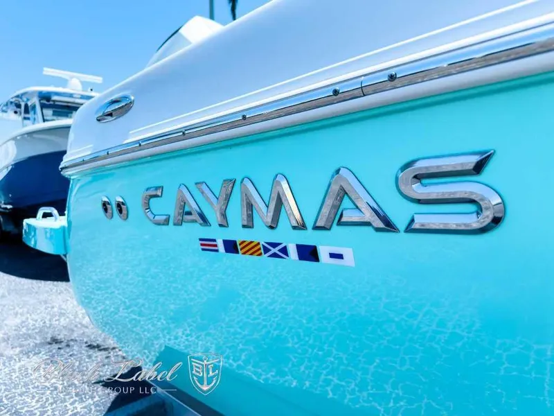 Slide: The Image of 2024 Caymas 281 HB boat console with Garmin displays in a warehouse setting. - 3