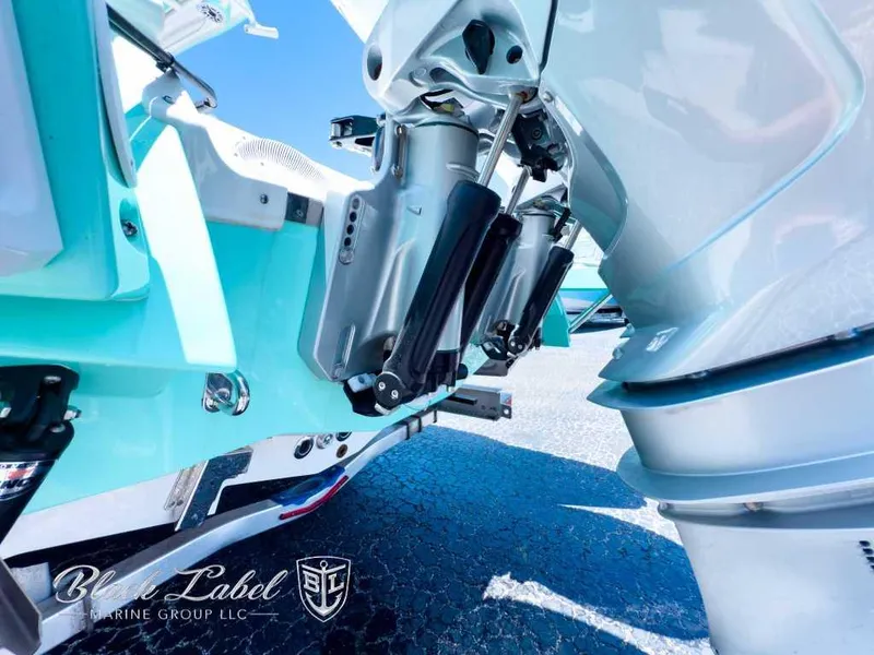 Slide: The Image of 2024 Caymas 281 HB boat with dual outboard engines, viewed from the rear deck. - 5