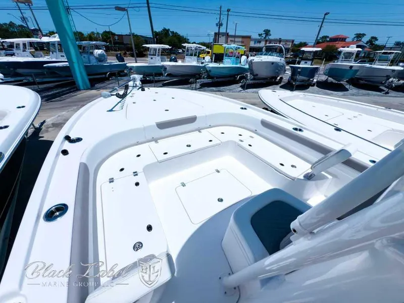 Slide: The Image of 2024 Caymas 281 HB boat dashboard with steering wheel and Mercury controls. - 6