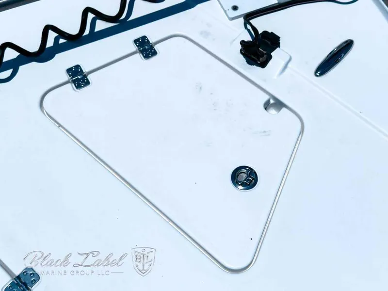 Slide: The Image of 2024 Caymas 281 HB boat displayed outdoors with other boats under a clear blue sky. - 8