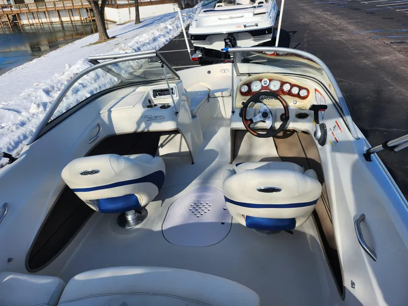 Slide: The Image of 2014 Tahoe Q5i SF boat interior with white seating and dashboard controls. - 10