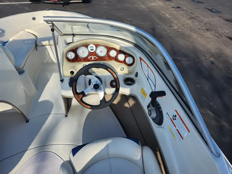 Slide: The Image of 2014 Tahoe Q5i SF boat dashboard with steering wheel and gauges. - 11