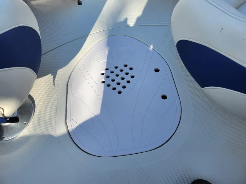 Slide: The Image of 2014 Tahoe Q5i SF boat interior with blue and white seating and floor drain. - 12