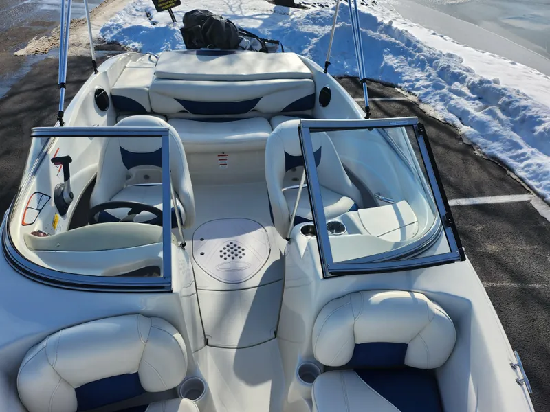 Slide: The Image of 2014 Tahoe Q5i SF boat with white and blue interior, parked on snowy pavement. - 19