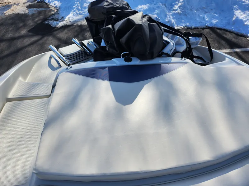 Slide: The Image of 2014 Tahoe Q5i SF boat with cushioned seating and equipment, parked on snowy ground. - 22