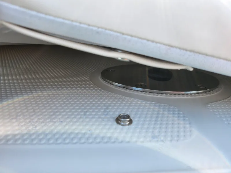 Slide: The Image of 2014 Tahoe Q5i SF boat seat detail with textured surface and metal fixture. - 23