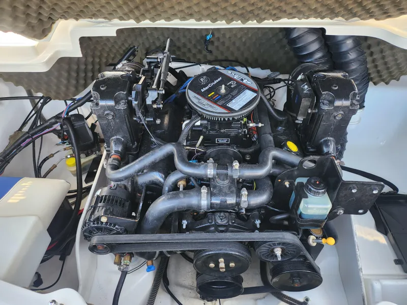 Slide: The Image of 2014 Tahoe Q5i SF boat engine compartment with visible components and wiring. - 24
