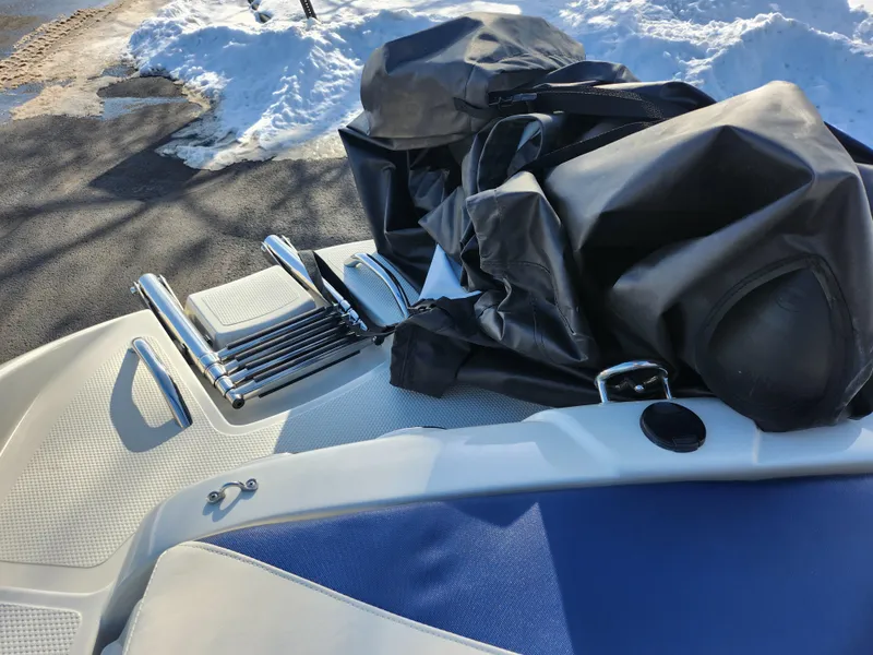 Slide: The Image of 2014 Tahoe Q5i SF boat with folded ladder and cover, parked on snowy pavement. - 25