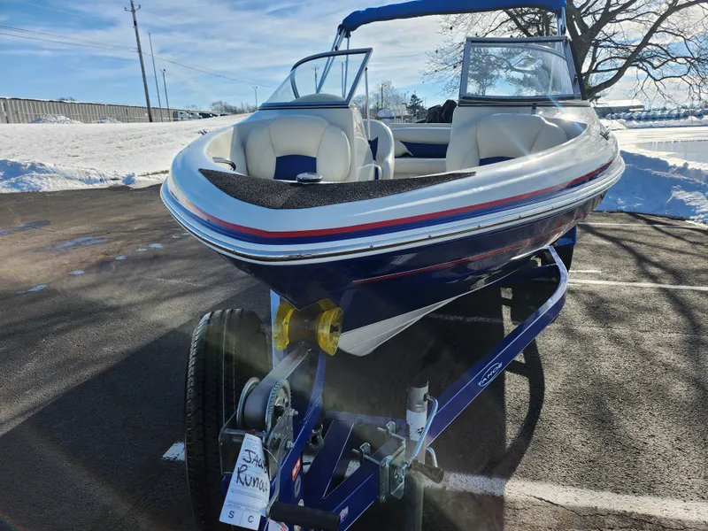 Slide: The Image of 2014 Tahoe Q5i SF boat on trailer in snowy parking lot. - 6
