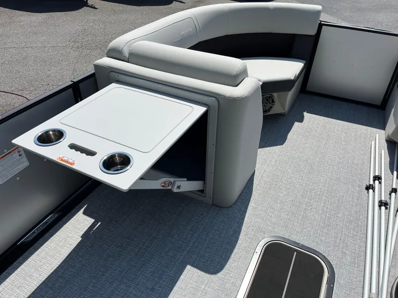 Slide: The Image of 2025 Harris Cruiser 210 interior with gray seating and fold-out table. - 10