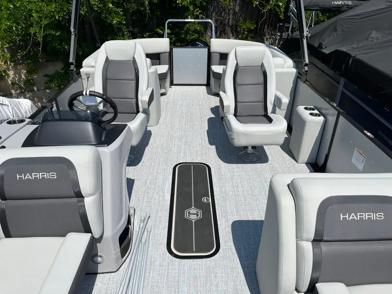 Slide: The Image of 2025 Harris Cruiser 210 boat interior with gray seating and modern design. - 16
