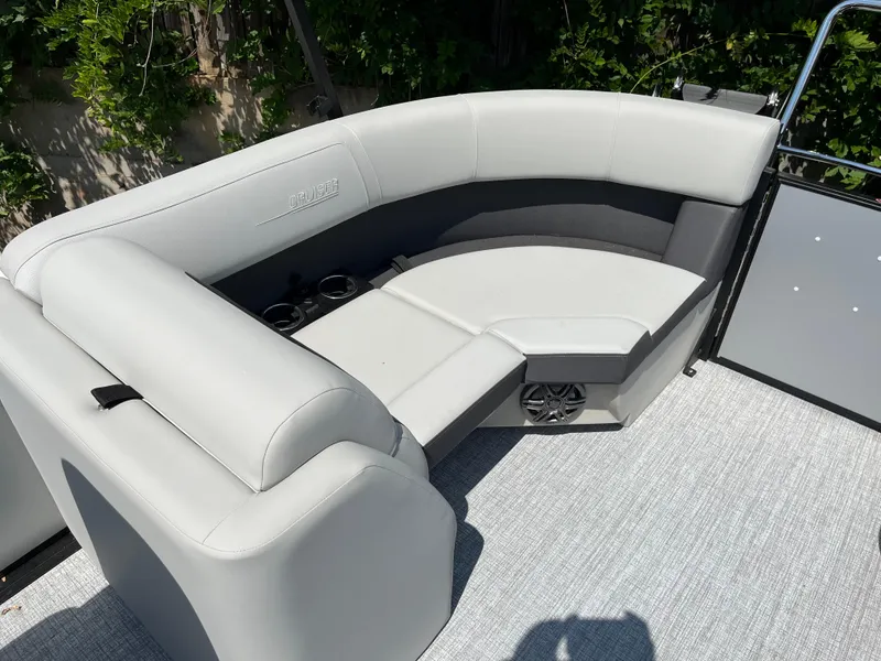 Slide: The Image of 2025 Harris Cruiser 210 boat interior with gray seating and cup holders. - 17