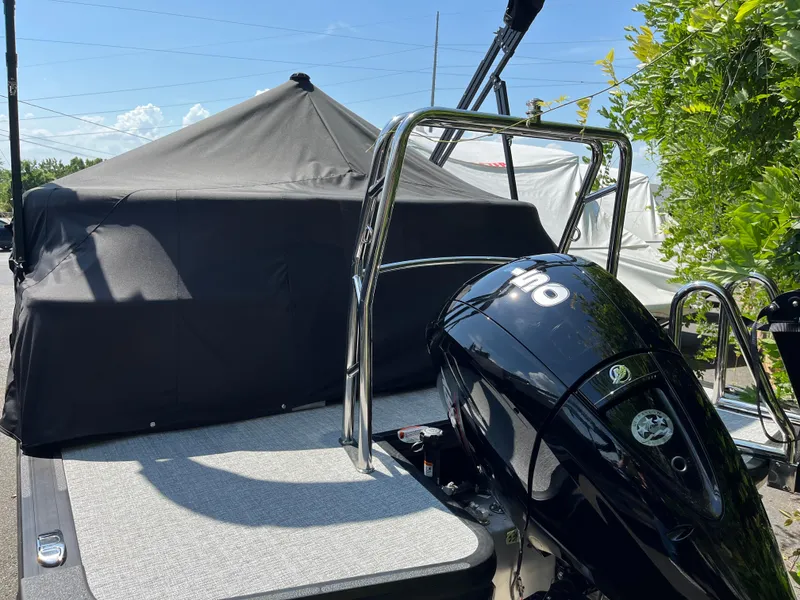 Slide: The Image of 2025 Harris Cruiser 210 boat with covered deck and outboard motor. - 3