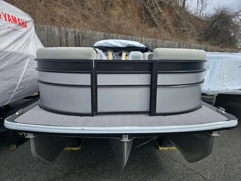 Slide: The Image of 2025 Harris Cruiser 210 pontoon boat, gray exterior, parked outdoors. - 4
