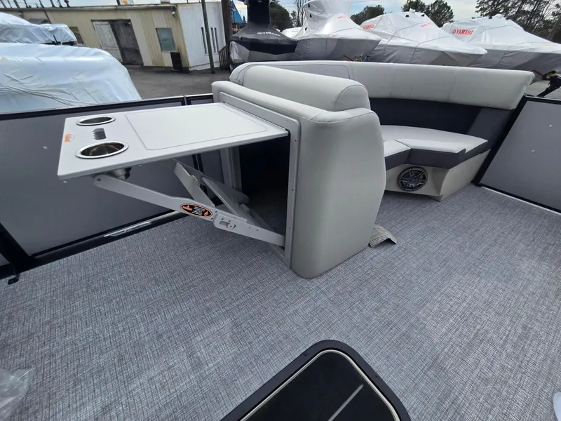Slide: The Image of 2025 Harris Cruiser 210 interior with gray seating and foldable table. - 6