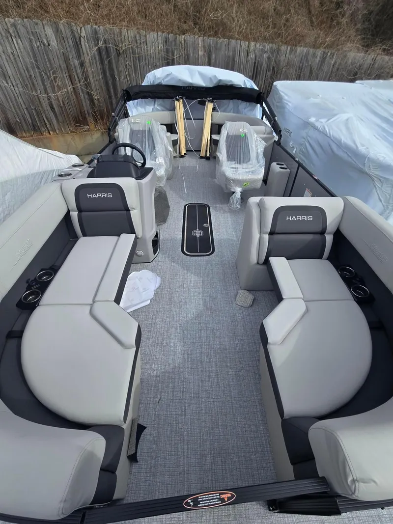Slide: The Image of 2025 Harris Cruiser 210 boat interior with gray seating and modern design. - 7