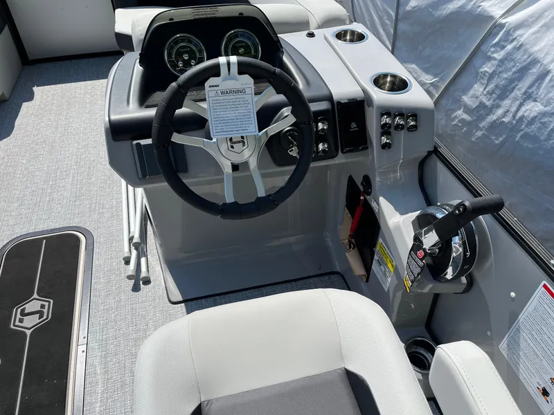 Slide: The Image of 2025 Harris Cruiser 210 boat dashboard with steering wheel and controls. - 8