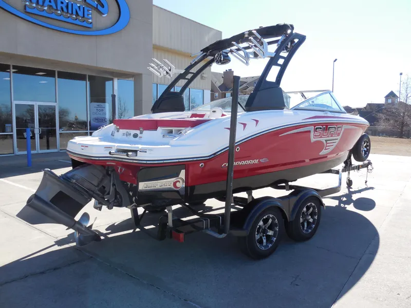 Slide: The Image of 2019 Chaparral 21 H2O Surf boat on trailer, parked outside a marine dealership. - 3