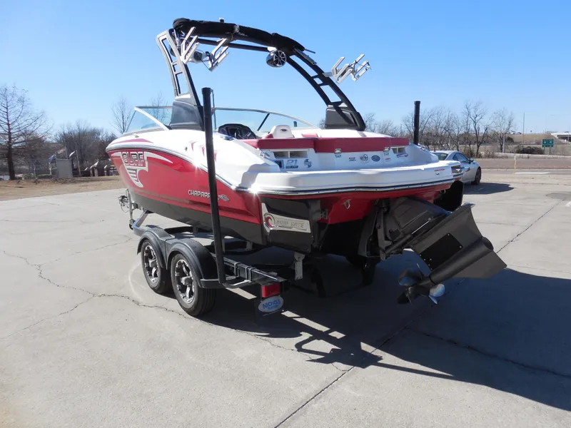 Slide: The Image of 2019 Chaparral 21 H2O Surf boat on trailer, red and white design, parked outdoors. - 4