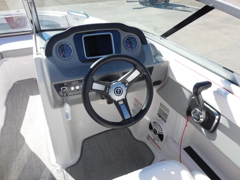 Slide: The Image of 2019 Chaparral 21 H2O Surf boat dashboard with steering wheel and controls. - 8