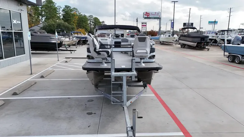 Slide: The Image of 2023 Avalon VEN 2180 FNC boat on trailer in dealership parking lot. - 12