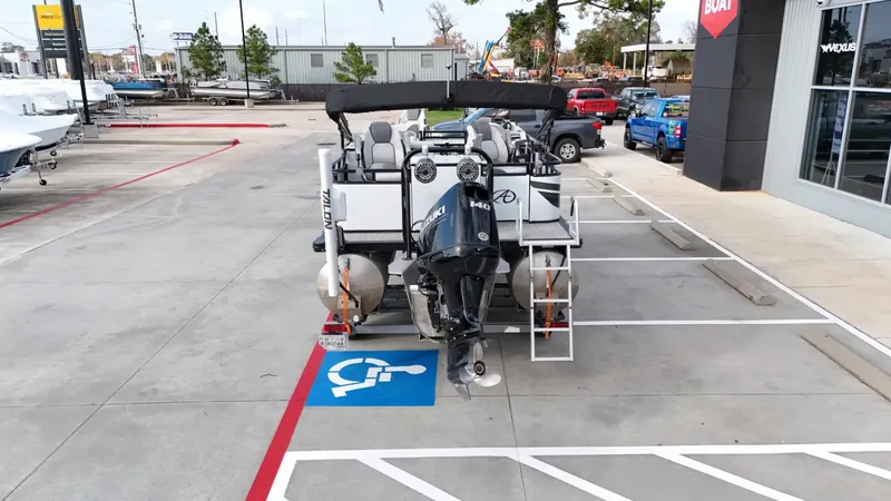 Slide: The Image of 2023 Avalon VEN 2180 FNC boat parked in a lot, near a handicap space. - 13