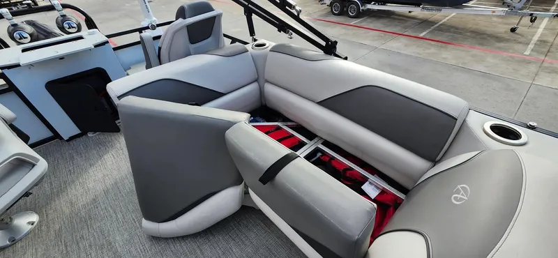 Slide: The Image of 2023 Avalon VEN 2180 FNC boat interior with gray seating and storage compartment. - 24