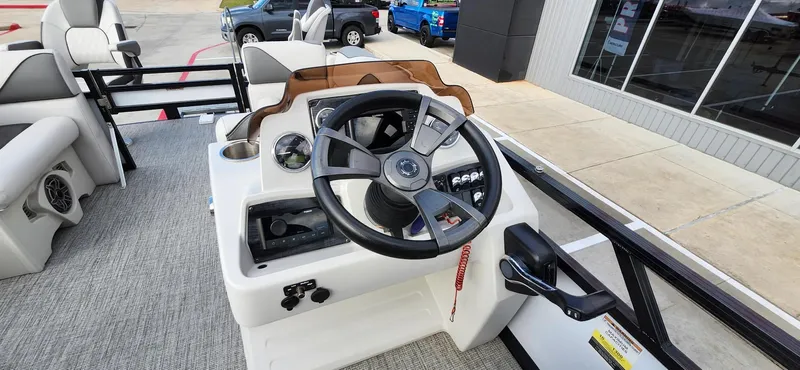 Slide: The Image of Steering console of 2023 Avalon VEN 2180 FNC boat, featuring modern controls and seating. - 32