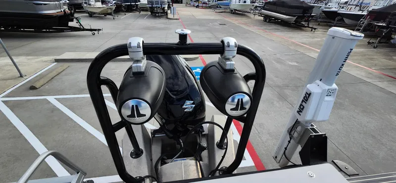 Slide: The Image of 2023 Avalon VEN 2180 FNC boat with speakers and motor in a marina. - 36