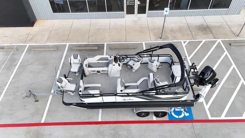 Slide: The Image of 2023 Avalon VEN 2180 FNC boat parked in a lot, aerial view. - 9