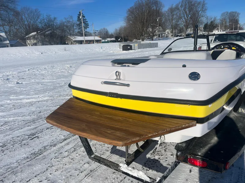 Slide: The Image of 2000 Correct Craft Ski Nautique boat on trailer in snowy landscape. - 10