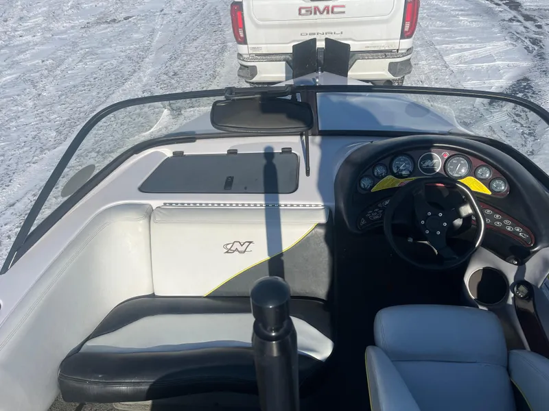 Slide: The Image of 2000 Correct Craft Ski Nautique interior with dashboard and steering wheel, parked near GMC truck. - 5